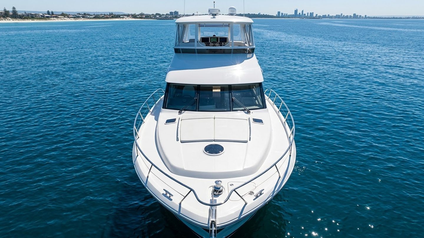 Caribbean Detailing technician polishing a boat on the water in Perth